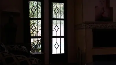 two stained glass windows in a room with a fireplace at Villa Zazate in Ouarzazate