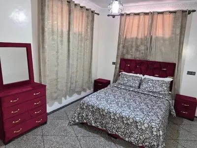 a bedroom with a bed and a mirror and a dresser at Villa avec piscine-Meknès in Oulad Akkou