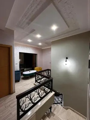 a living room with stairs and a living room at Villa avec piscine in Meknès