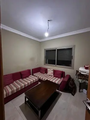 a living room with a couch and a table at Villa avec piscine in Meknès