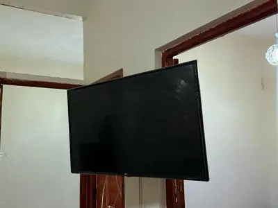 a flat screen tv hanging on a wall at hôtel kawtar in Meknès
