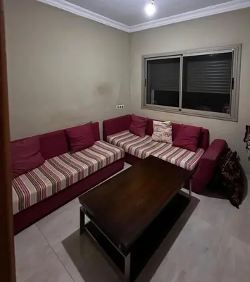 a living room with a couch and a coffee table at Villa élégante in Meknès