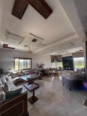 a large living room with couches and a tv at Villa Lina in Meknès