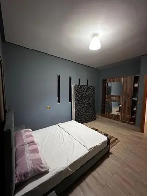 a bedroom with a bed and a blue wall at Villa élégante in Aït Ali Ou Moussa