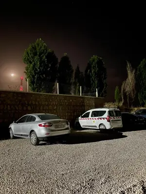 two cars parked in a parking lot at night at Cozy apartment in Ifrane in Ifrane