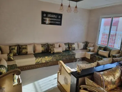 a living room with a couch and a table at Vip charme in Fès