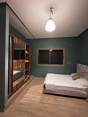 a bedroom with a bed and a window in it at Villa Adam in Meknès