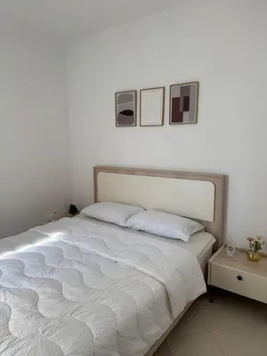 a bed in a bedroom with two pictures on the wall at Fès comfort stay in Fès