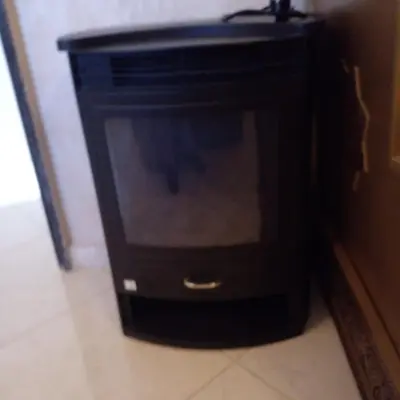 a black cabinet with a television in a room at Vip apartment in Fès