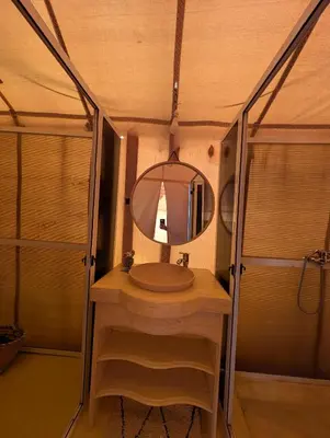 a bathroom with a sink and a mirror at Luxury Desert Camp with AC & Heating in Merzouga in Lac Yasmins