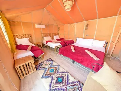 a room with two beds in a tent at Air Conditioning Berber Desert Camp in Merzouga