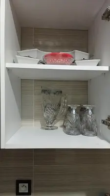 a shelf with three glass vases on it at Reda Ghazalie in Meknès