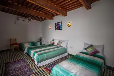 a bedroom with two beds in a room at Dar Miouda Fes in Fès