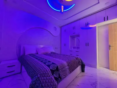 a purple bedroom with a bed with a purple ceiling at Bella Nova Air-Conditioned Apartment in Azrou