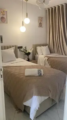 two beds sitting next to each other in a bedroom at شقة فخمة وهادئة in Ifrane