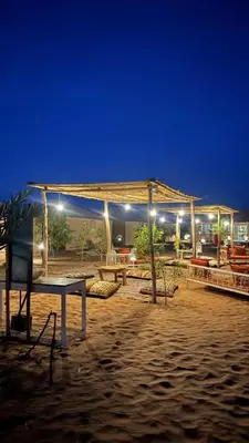 a pavilion on the beach at night with lights at Desert luxury in Merzouga