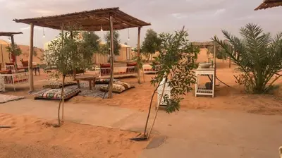 a picnic area in the middle of a desert at Desert luxury in Merzouga