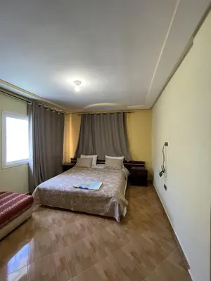 a bedroom with a large bed and a window at Ferme Erraha in Bhalil