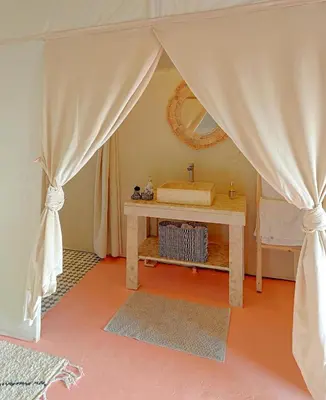 a dressing room with a table and a mirror at Sahara Spirit luxury Camp in Merzouga