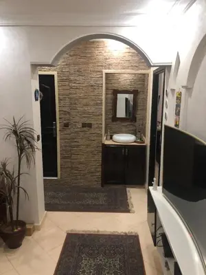 a bathroom with a sink and a mirror at Appart familial moderne de luxe Location journalière ou longue durée in Khemisset