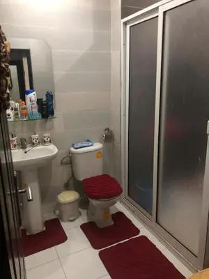 a bathroom with a shower and a toilet and a sink at Appartement moderne et entièrement meublé in Khemisset