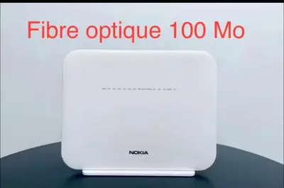 a white router sitting on top of a table at Fabuleux appartement au Centre Ville avec Wifi 100 Mo in Fès
