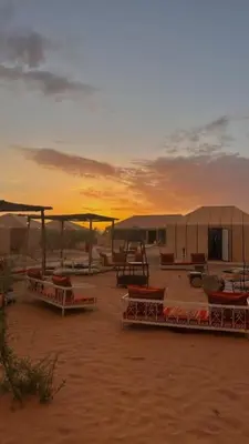 a group of tents in the desert at sunset at Desert luxury in Merzouga
