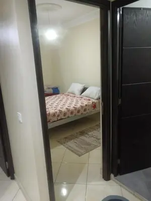 a small bedroom with a bed in a room at Appart hôtel tanger in Oulad Akkou