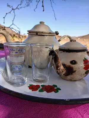 a tea pot and two glasses on a table at Agoudim Nikhartan in Tinerhir
