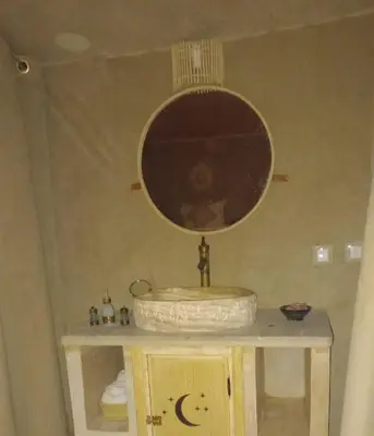 a bathroom with a sink and a mirror at Merzouga Dream Starlight in Merzouga