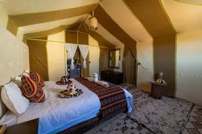a bedroom with a bed with animals on it at Avatar Luxe Camp in Merzouga