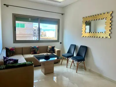 a living room with a couch and chairs and a mirror at Appart Hotel Noor Fes - Family & Traveler Apartments in Fès