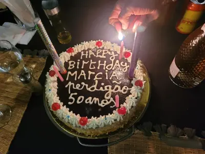 a birthday cake with a candle on a table at Merzouga delicioso Camp in Oulad Akkou