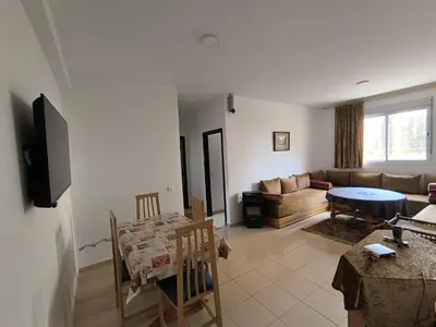a living room with a couch and a table at Les jardins d'Ifrane in Ifrane