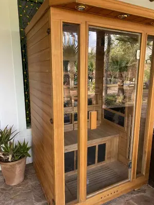 a wooden room with a wooden door with windows at Suite avec salle de bain privée das un beau Riad avec piscine in Aghmat