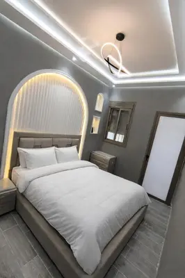 a bedroom with a large white bed and a ceiling at Appartment in hearth of new Fes in Fès