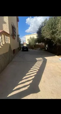 a shadow of a car parked on a street at Villa appartement jardin et piscine in Meknès