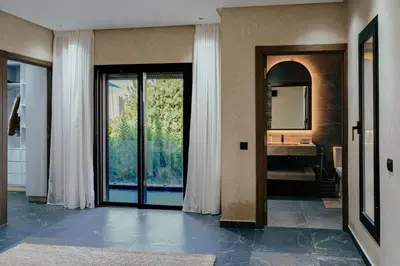 a bathroom with a sink and a door with a mirror at Romilli atlas in Sbiti