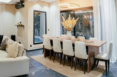 a dining room with a table and chairs at Romilli atlas in Sbiti