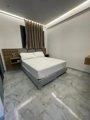 a bedroom with a large bed and a marble floor at Hôtel kairouan in Fès