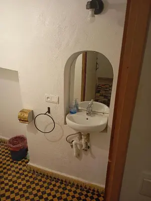 a bathroom with a sink and a mirror at Dar al mardi fes luxury in Fès