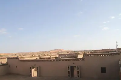 a building in the middle of the desert at dorada apartamento in Merzouga