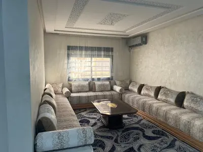 a living room with a couch and a table at Université luxe appart2 in Fès