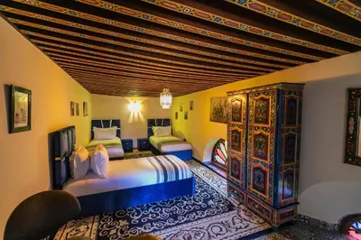 a bedroom with two beds in a room at Riad Fez social club in Fès
