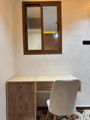 a desk with a mirror and a white chair at Meknes Relax Home in Meknès