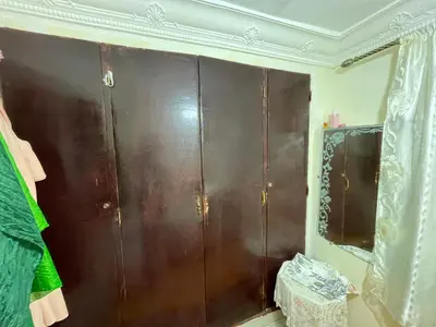 a brown cabinet in a room with a mirror at فاس in Fès
