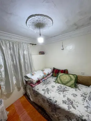 a bedroom with a bed and a chandelier at فاس in Fès