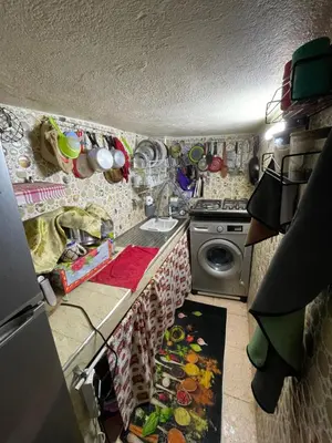 a kitchen with a sink and a washing machine at فاس in Fès
