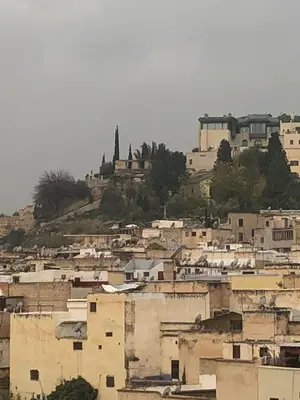 a group of buildings on top of a hill at khamsin home in Fès