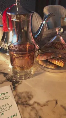 a cup of tea and a plate of food on a table at khamsin home in Fès